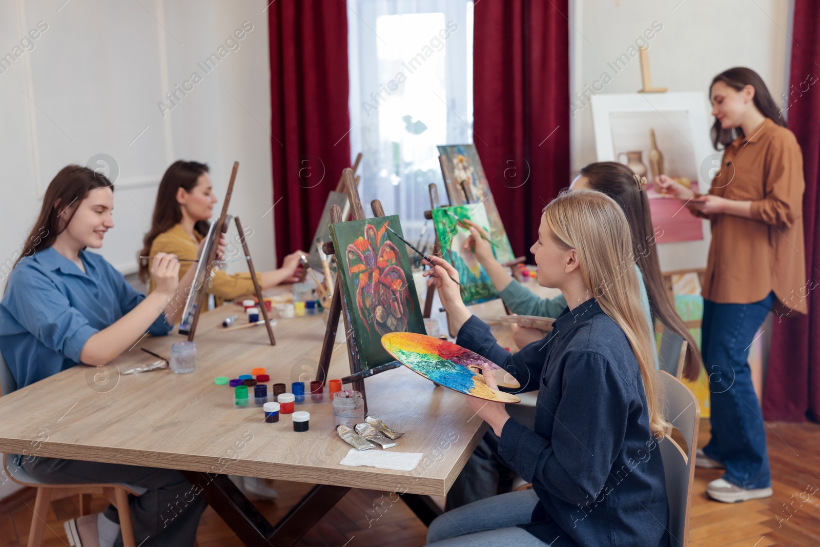 Photo of Group of women learning to draw at table in class