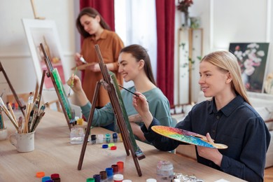 Group of women learning to draw at table in class