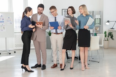 Portrait of happy coworkers in formal clothes indoors