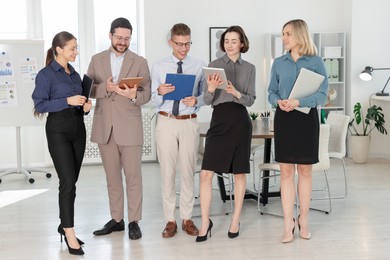 Photo of Portrait of happy coworkers in formal clothes indoors