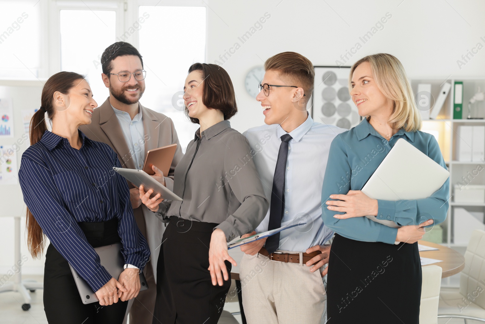 Photo of Portrait of happy coworkers in formal clothes indoors