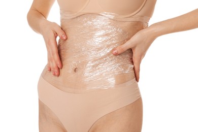 Woman doing spa body wraps on her belly against white background, closeup