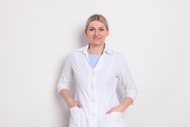 Photo of Portrait of professional dentist on white background