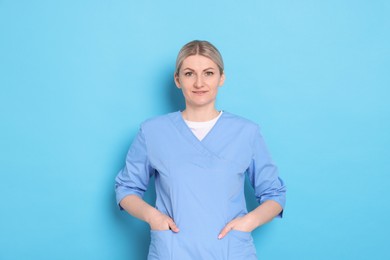 Photo of Portrait of professional dentist on light blue background