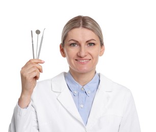 Photo of Professional dentist with tools on white background