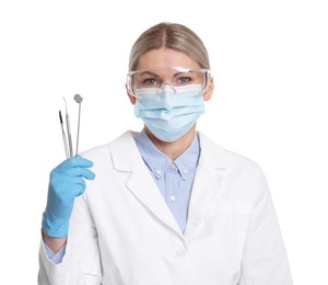 Photo of Professional dentist with tools on white background