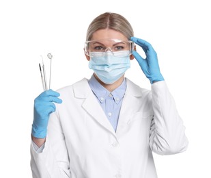 Photo of Professional dentist with tools on white background