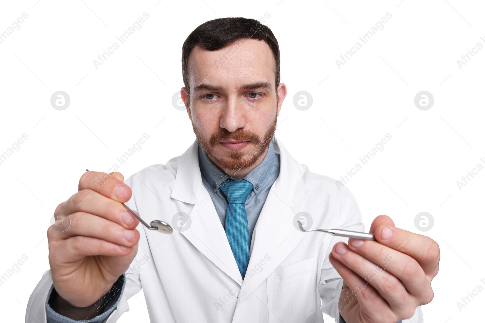 Photo of Professional dentist with tools on white background