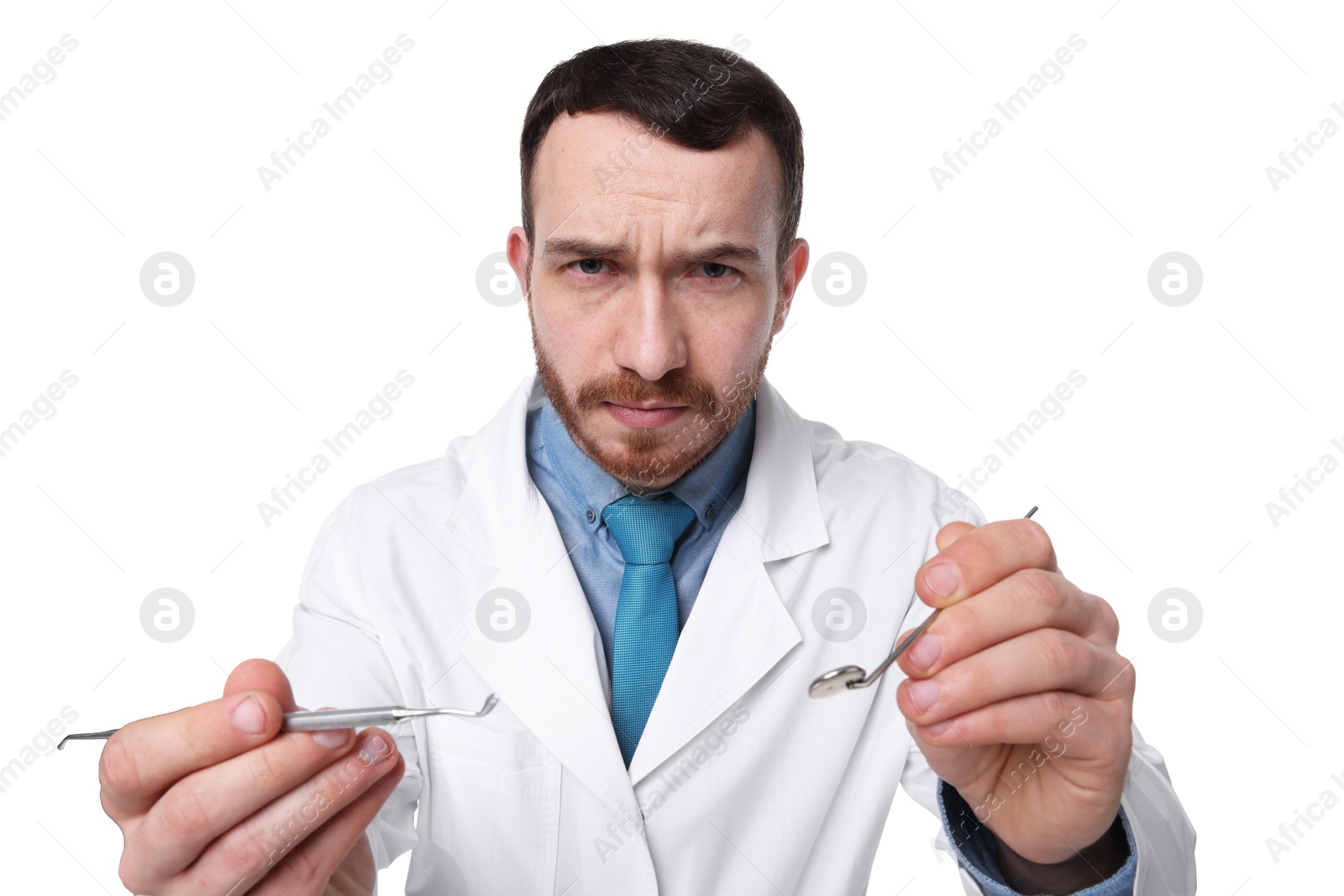 Photo of Professional dentist with tools on white background