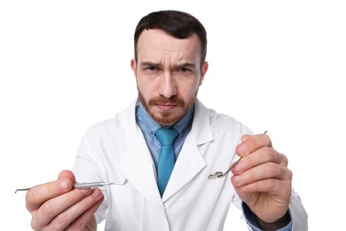 Photo of Professional dentist with tools on white background