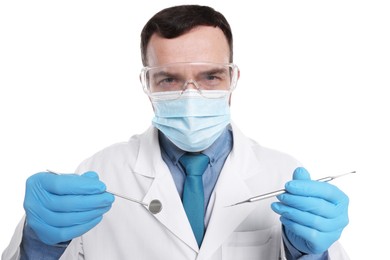 Photo of Professional dentist with tools on white background