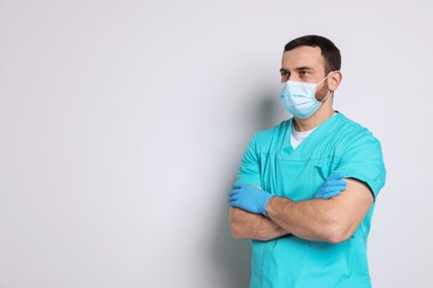 Portrait of professional dentist on light background. Space for text