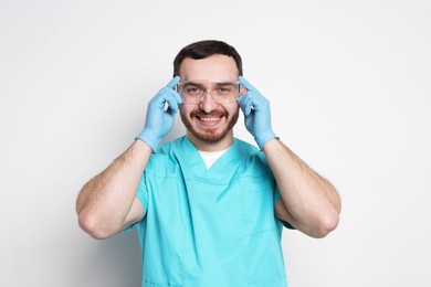 Portrait of professional dentist on light background