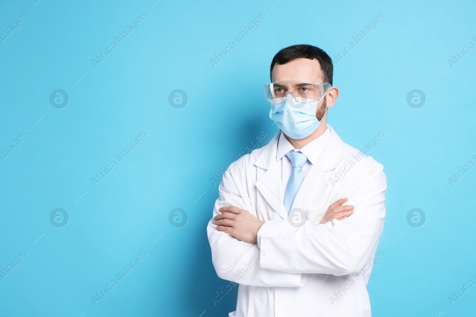 Photo of Portrait of professional dentist on light blue background. Space for text