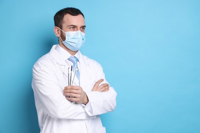 Photo of Professional dentist with tools on light blue background. Space for text