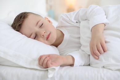 Photo of Bedtime. Cute boy sleeping in comfortable bed