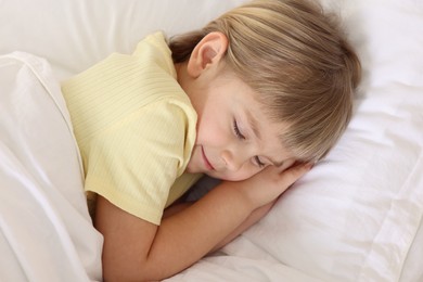 Photo of Bedtime. Cute little girl sleeping in bed, above view