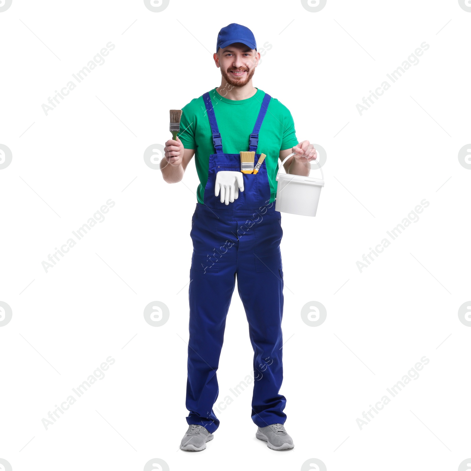 Photo of Professional painter with brush and bucket of paint on white background