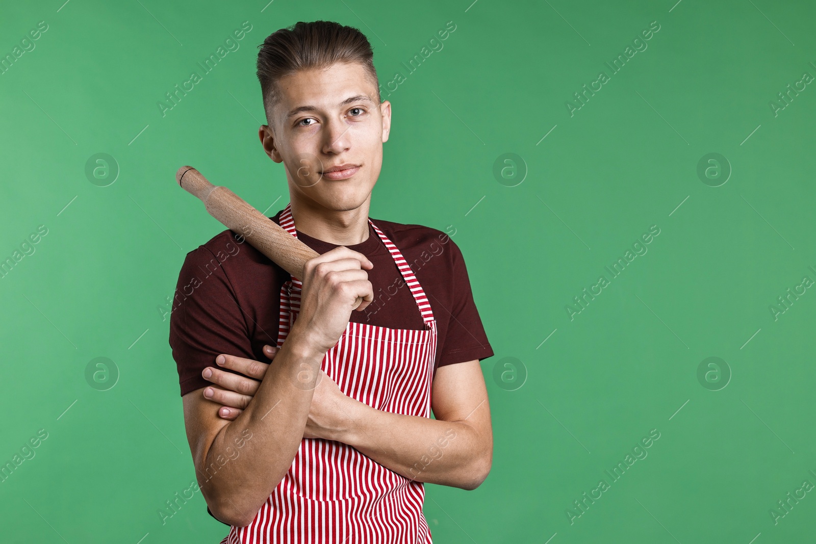 Photo of Man with rolling pin on green background