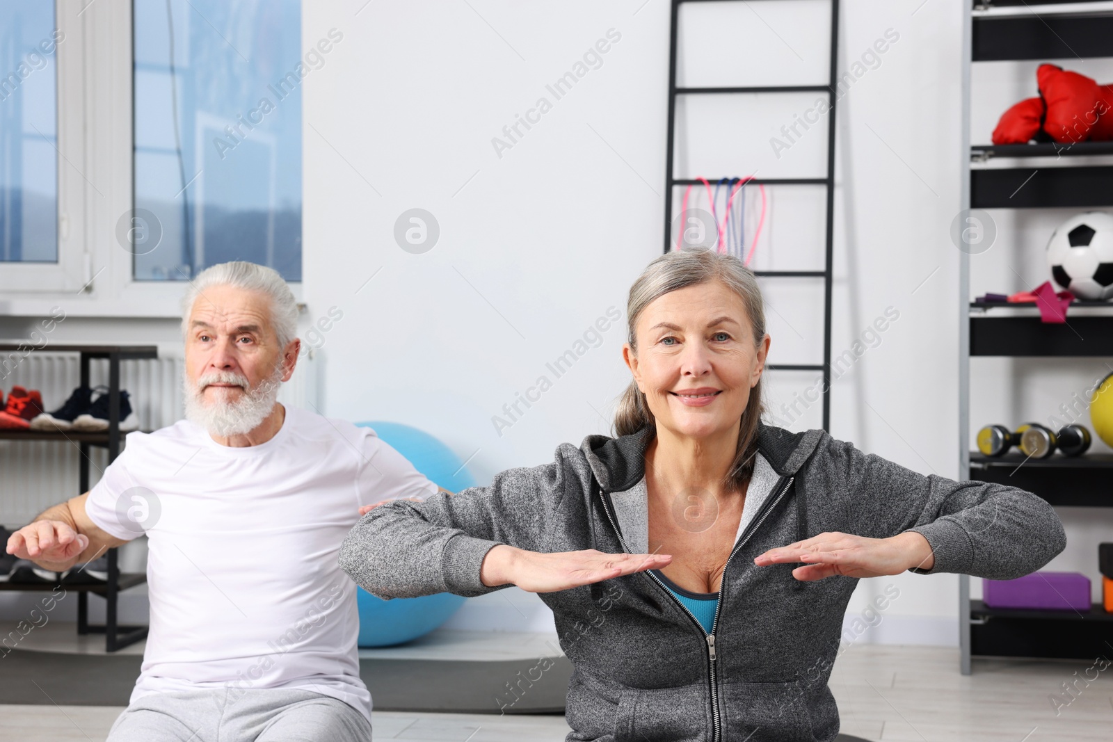 Photo of Elderly couple exercising at home. Healthy leisure