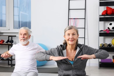 Elderly couple exercising at home. Healthy leisure