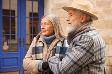 Photo of Lovely elderly couple holding hands on city street