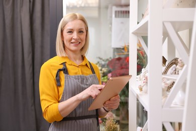 Photo of Business owner with tablet in her flower shop