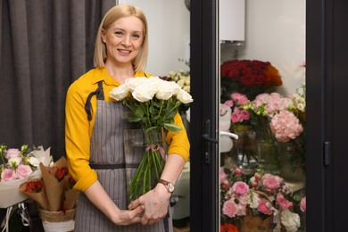 Photo of Business owner with beautiful roses in her flower shop