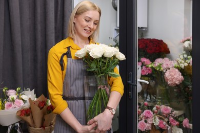 Photo of Business owner with beautiful roses in her flower shop