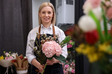 Business owner making beautiful bouquet in her flower shop