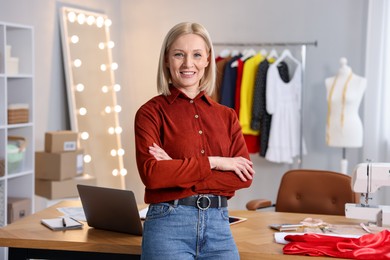 Photo of Business owner with crossed arms in her tailor shop