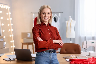 Photo of Business owner with crossed arms in her tailor shop