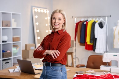 Photo of Business owner with crossed arms in her tailor shop