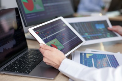 Stock exchange. Woman working at desk in office, closeup