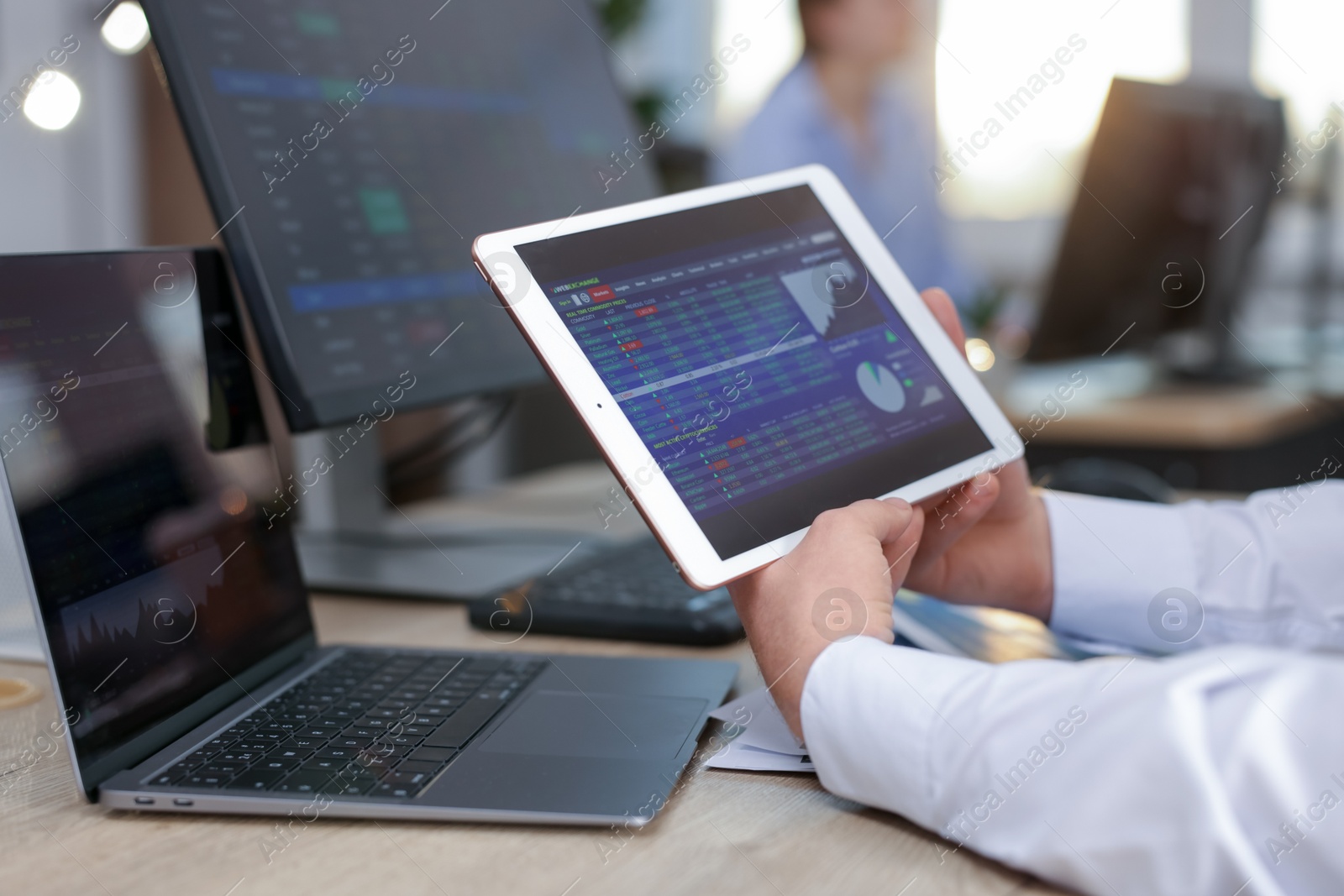 Photo of Stock exchange. Man working at desk in office, closeup