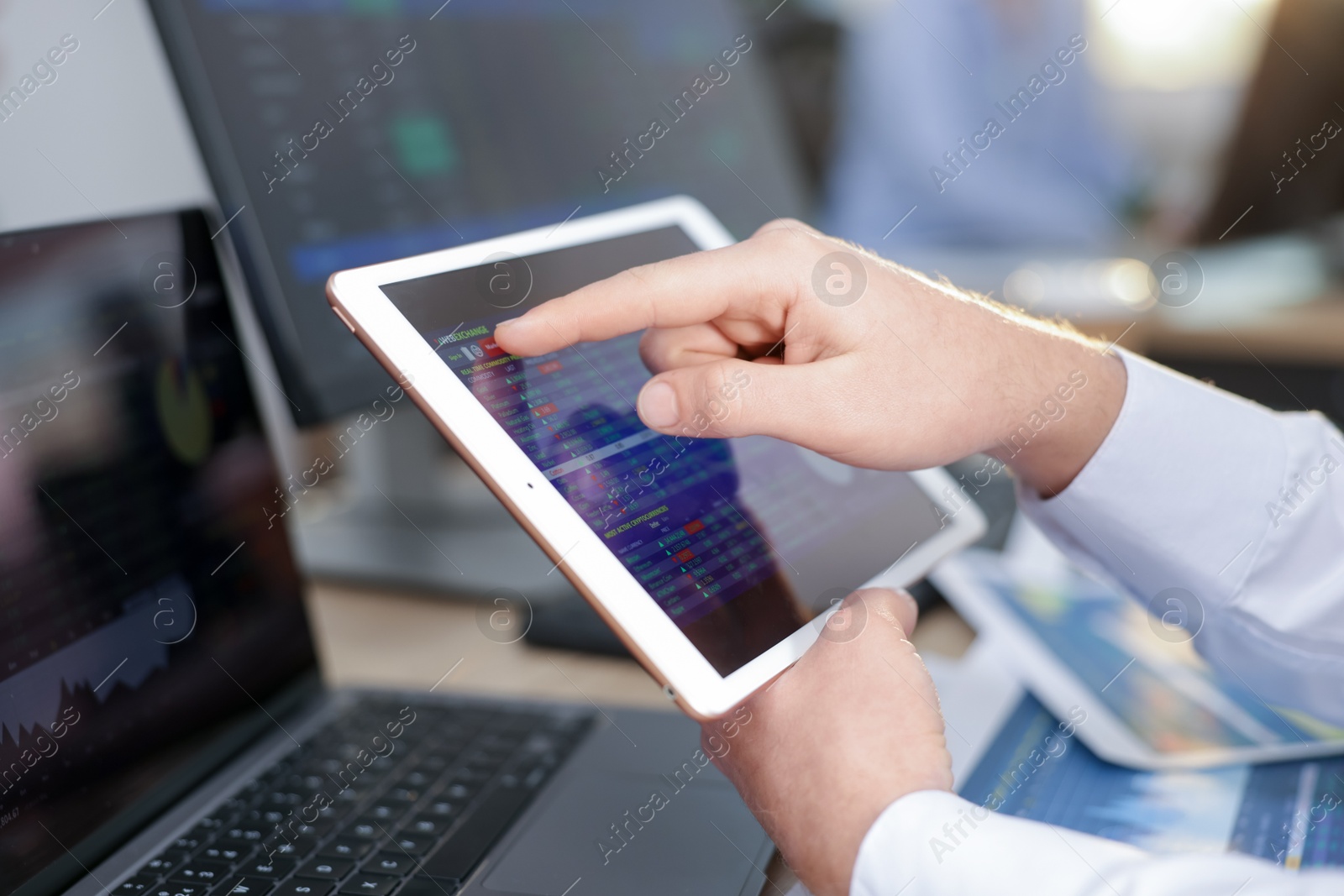 Photo of Stock exchange. Man working at desk in office, closeup