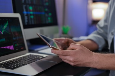 Stock exchange. Man working in office at night, closeup