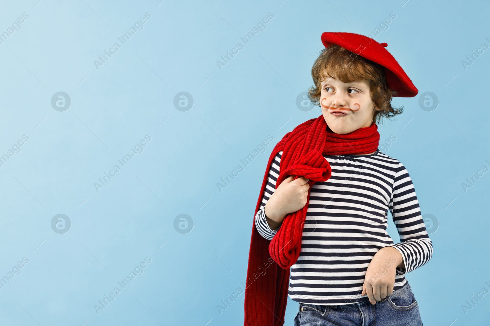 Photo of Cute boy in mime costume on light blue background, space for text. Surprise party