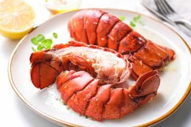 Photo of Delicious tails of boiled lobsters served on white table, closeup