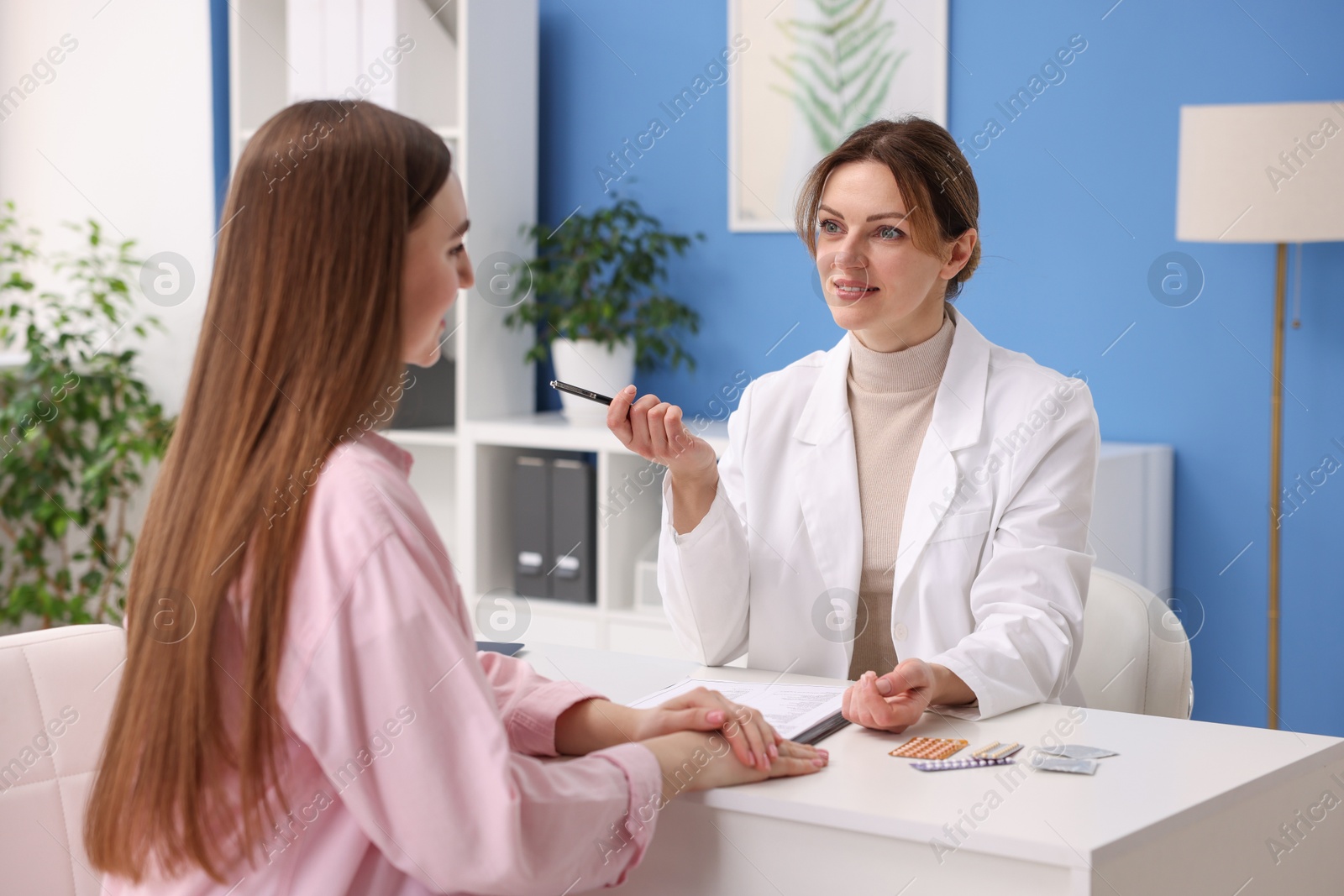 Photo of Contraception. Woman having appointment with gynecologist in clinic