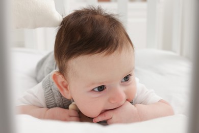 Photo of Cute little baby in crib at home