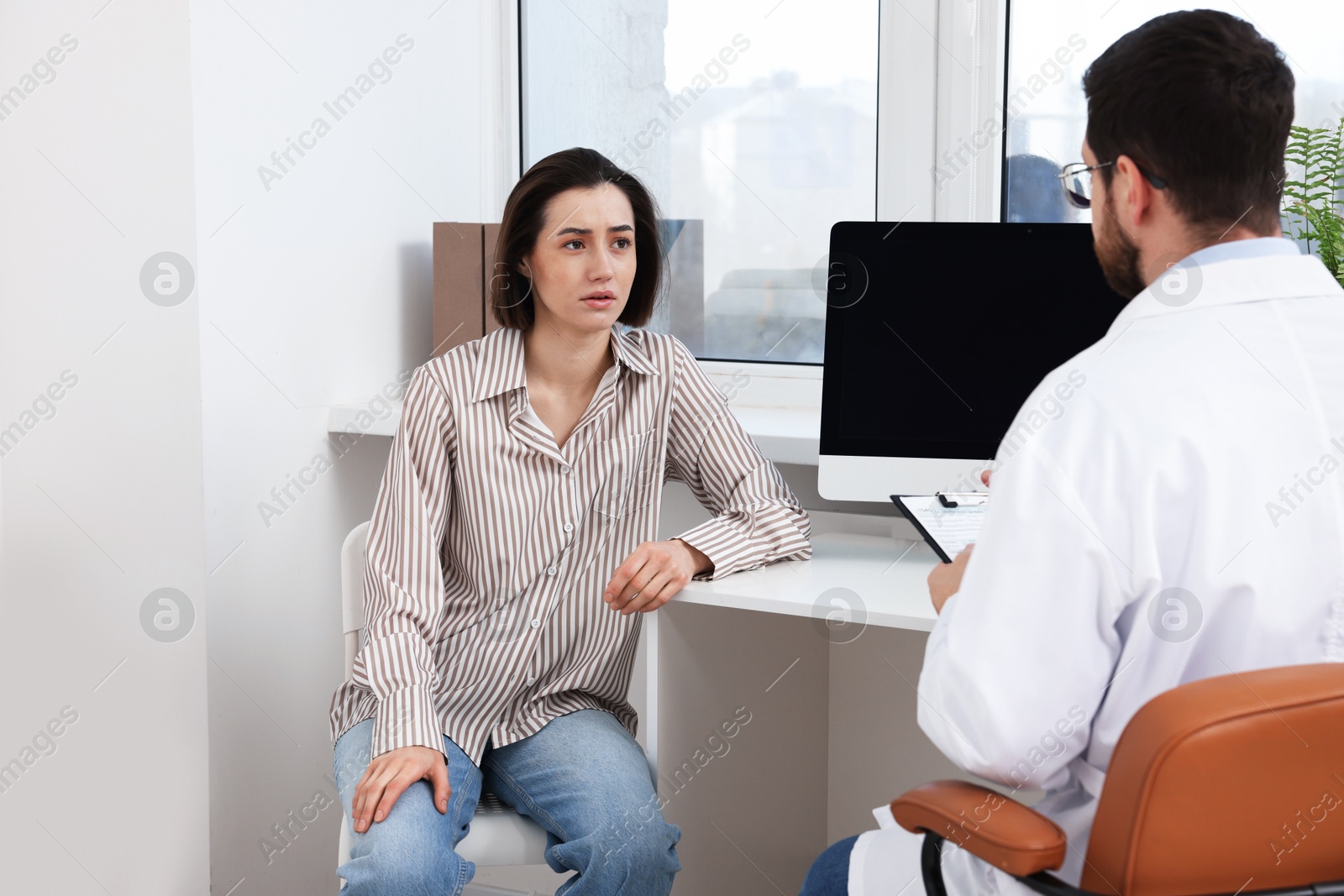 Photo of Dependent woman having appointment with addiction specialist in clinic