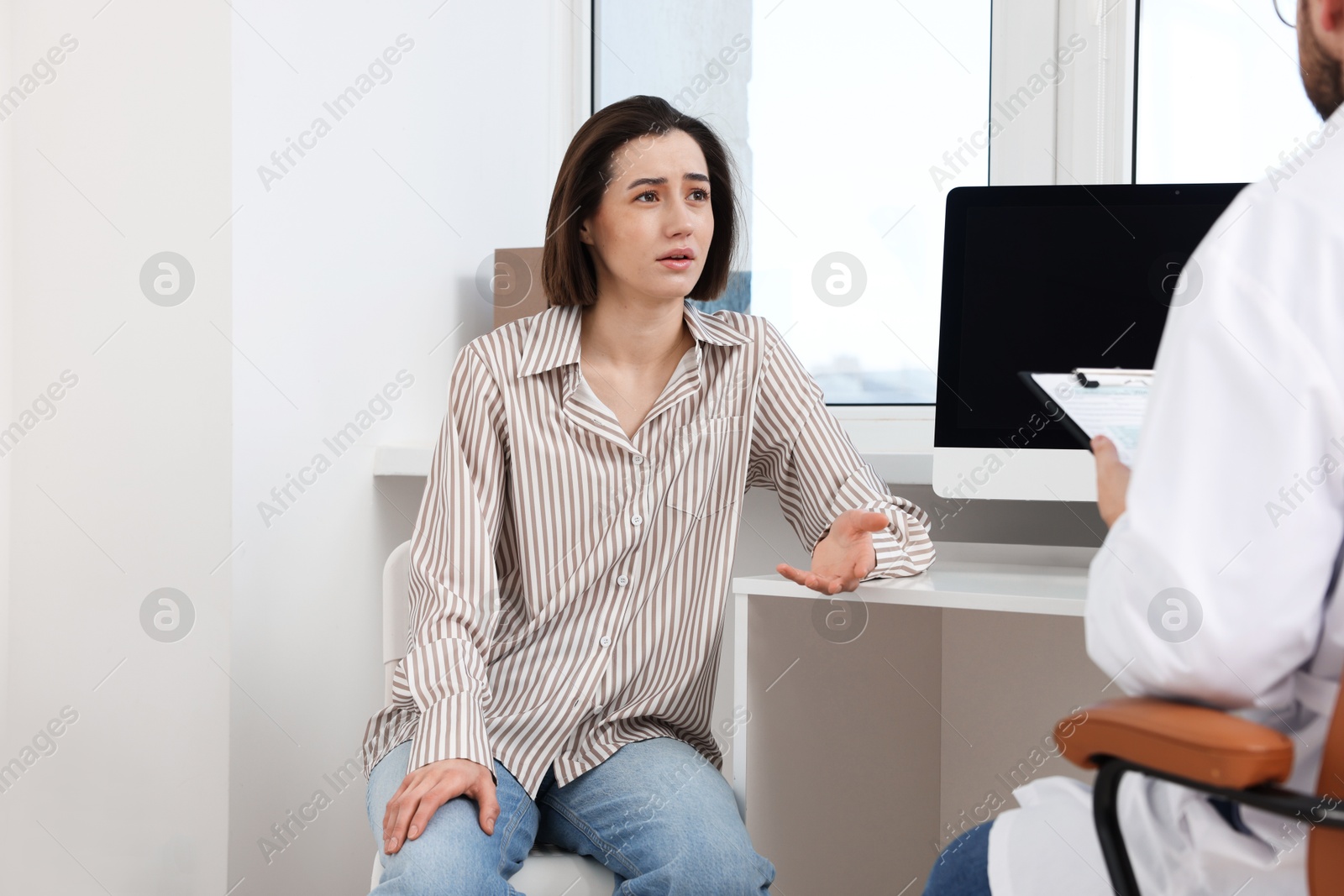 Photo of Dependent woman having appointment with addiction specialist in clinic