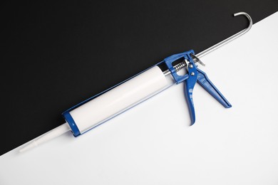 Photo of One glue gun on color background, top view