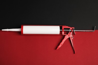 Photo of One glue gun on color background, top view