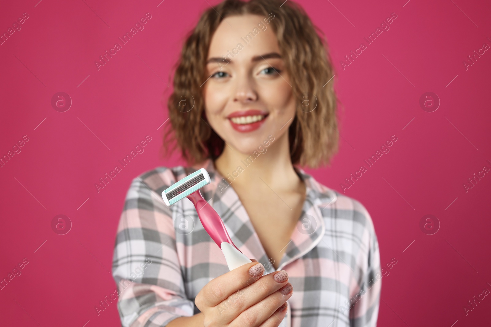 Photo of Happy woman with razor on pink background, selective focus. Hair removal tool