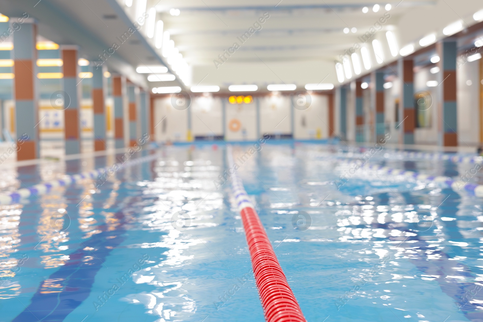 Photo of Swimming pool with clean water and lane dividers indoors, closeup