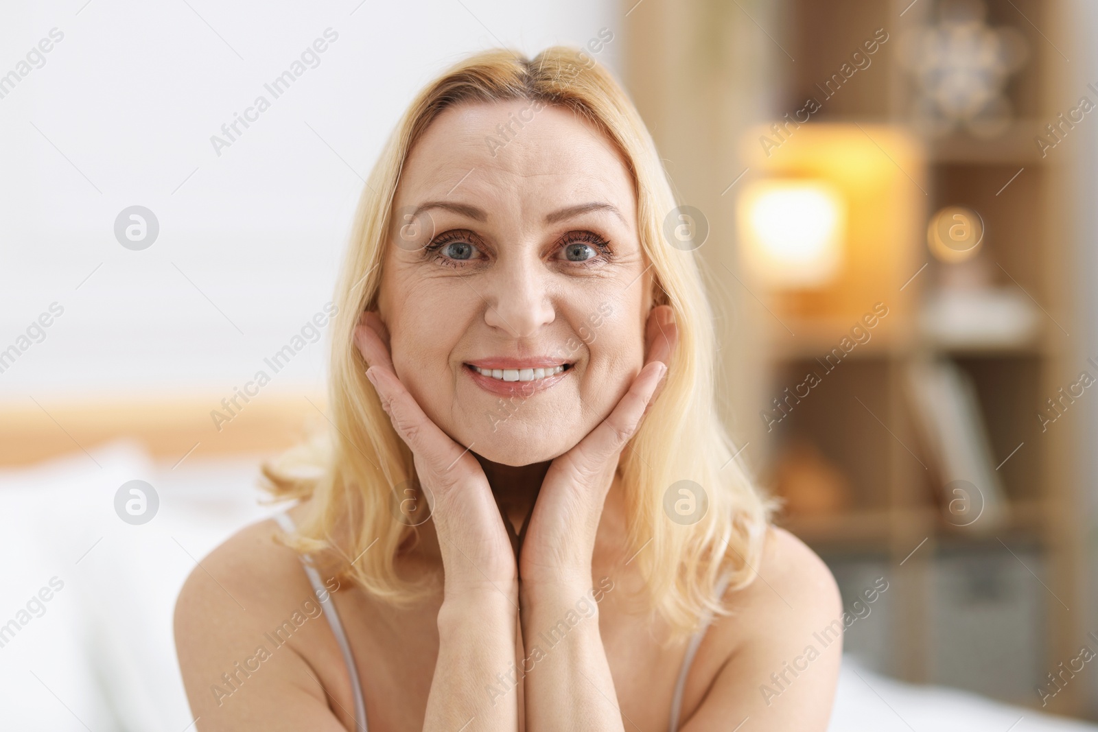 Photo of Portrait of smiling middle aged woman at home