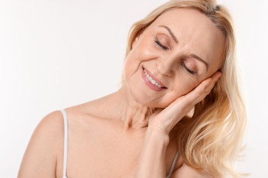 Photo of Smiling middle aged woman on white background