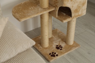 Photo of Stylish cat tree in living room, closeup